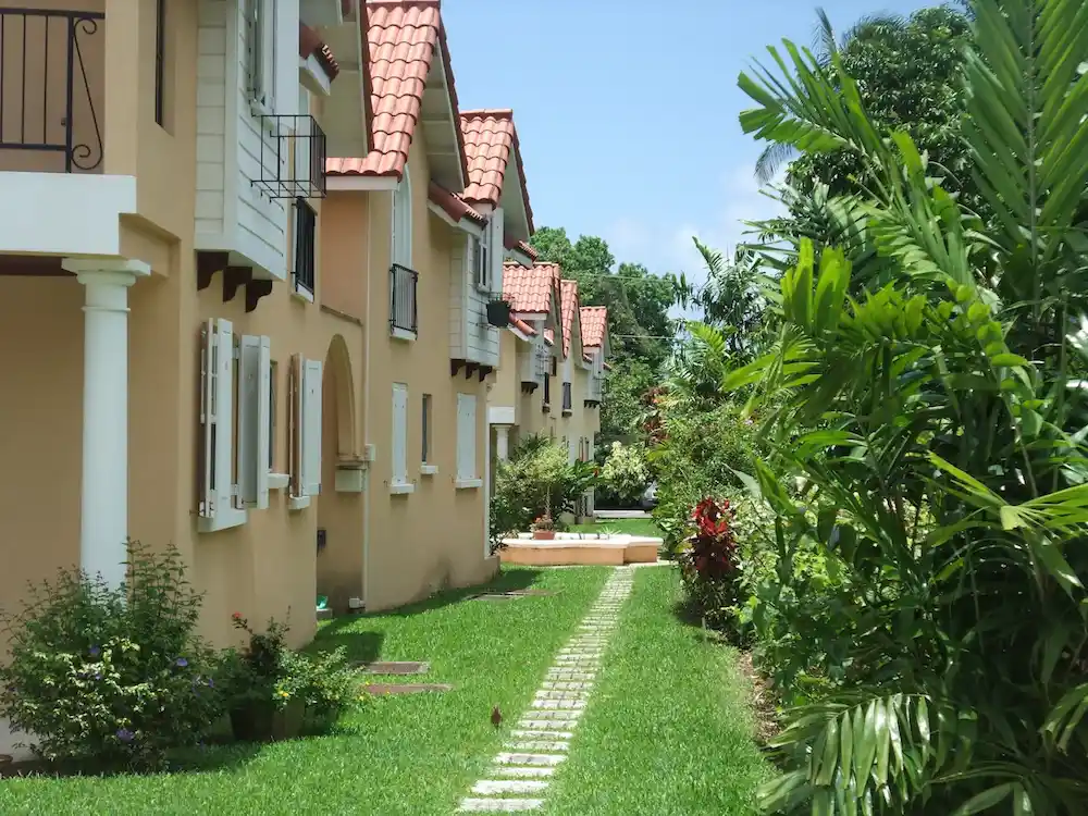 Lush tropical garden path and apartment exteriors at 7 Springcourt, Barbados.