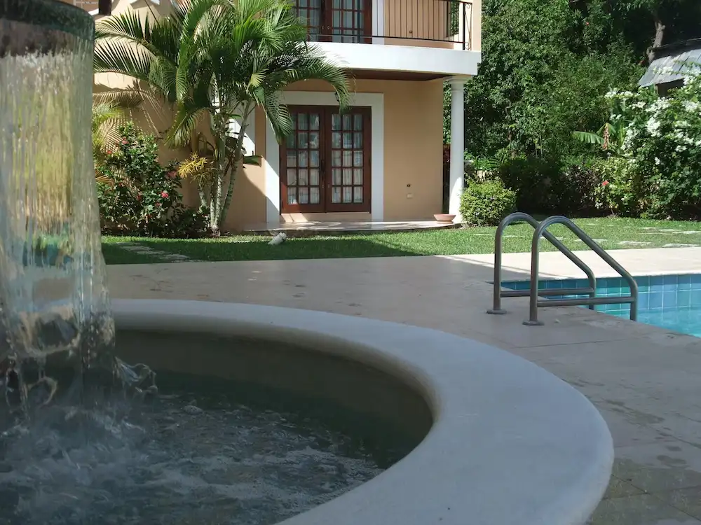 Waterfall feature at the communal pool of 7 Springcourt in Rockley, Barbados.